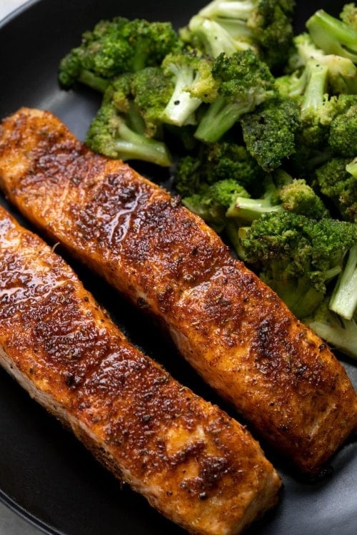 Salmon fried in an Air fryer, with tender meat, crispy skin and flavorful mix-herb seasoning.