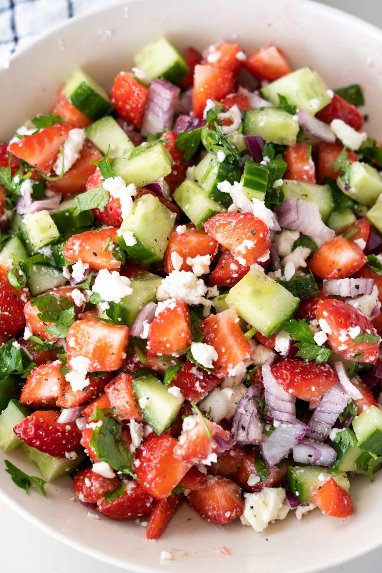 A fresh and fruity chopped Strawberry Cucumber Salad with feta cheese, onions and olive oil.