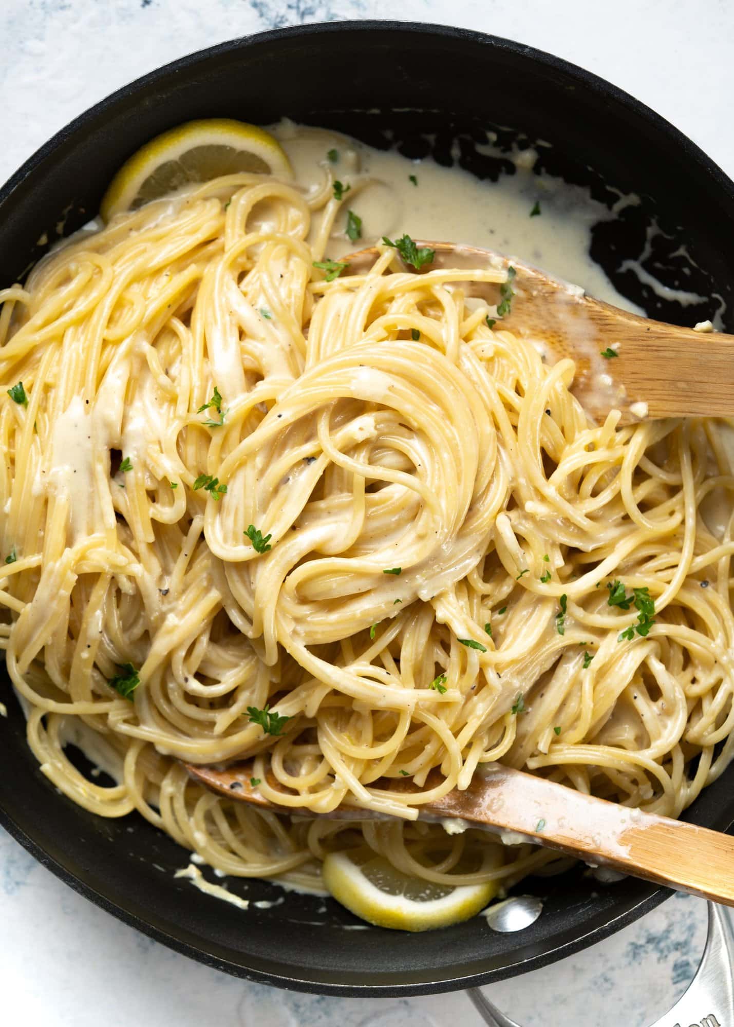 One-pot pasta with a lemony creamy sauce made in a black skillet with straight sides.