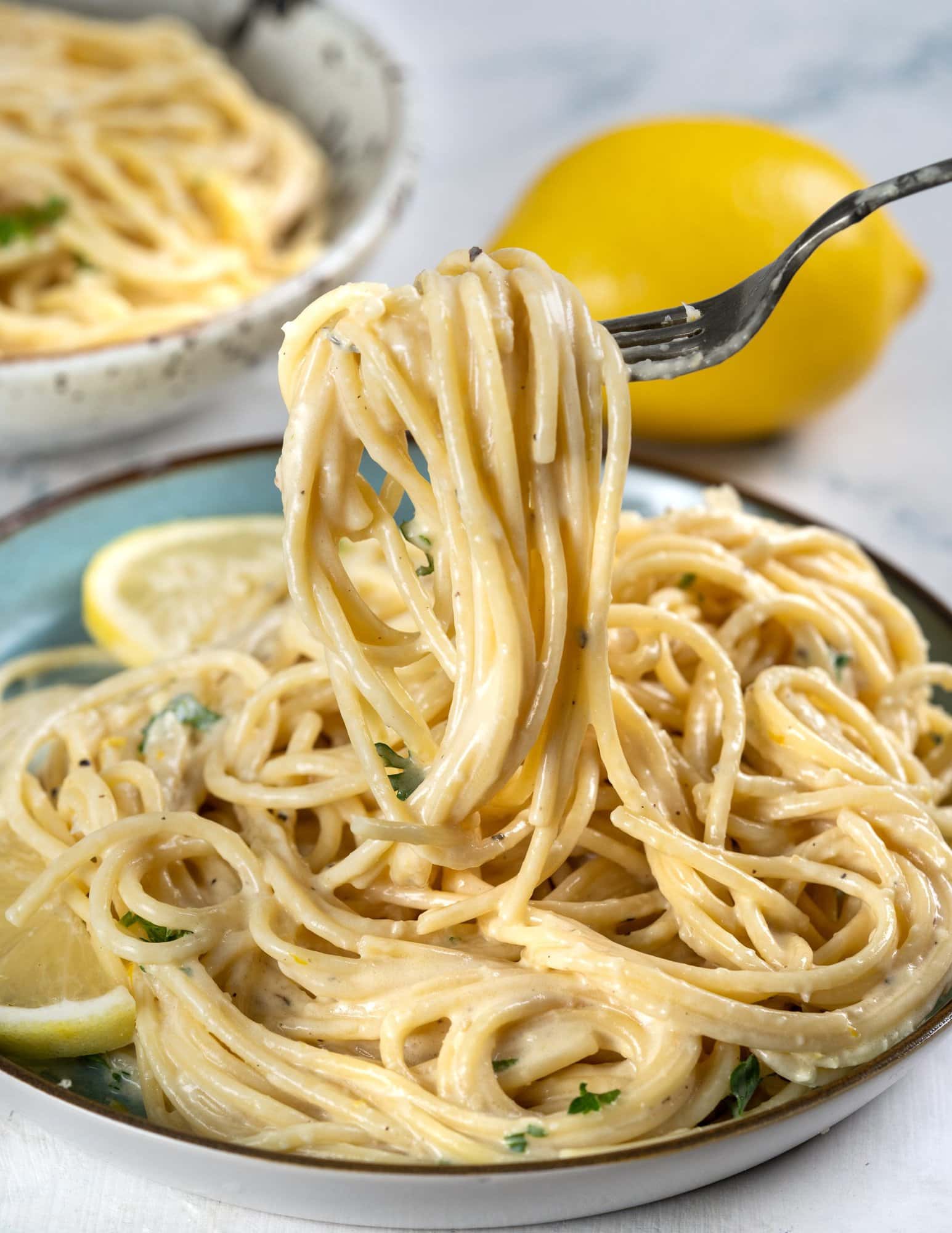 One-pot pasta picked on a fork from a plate.