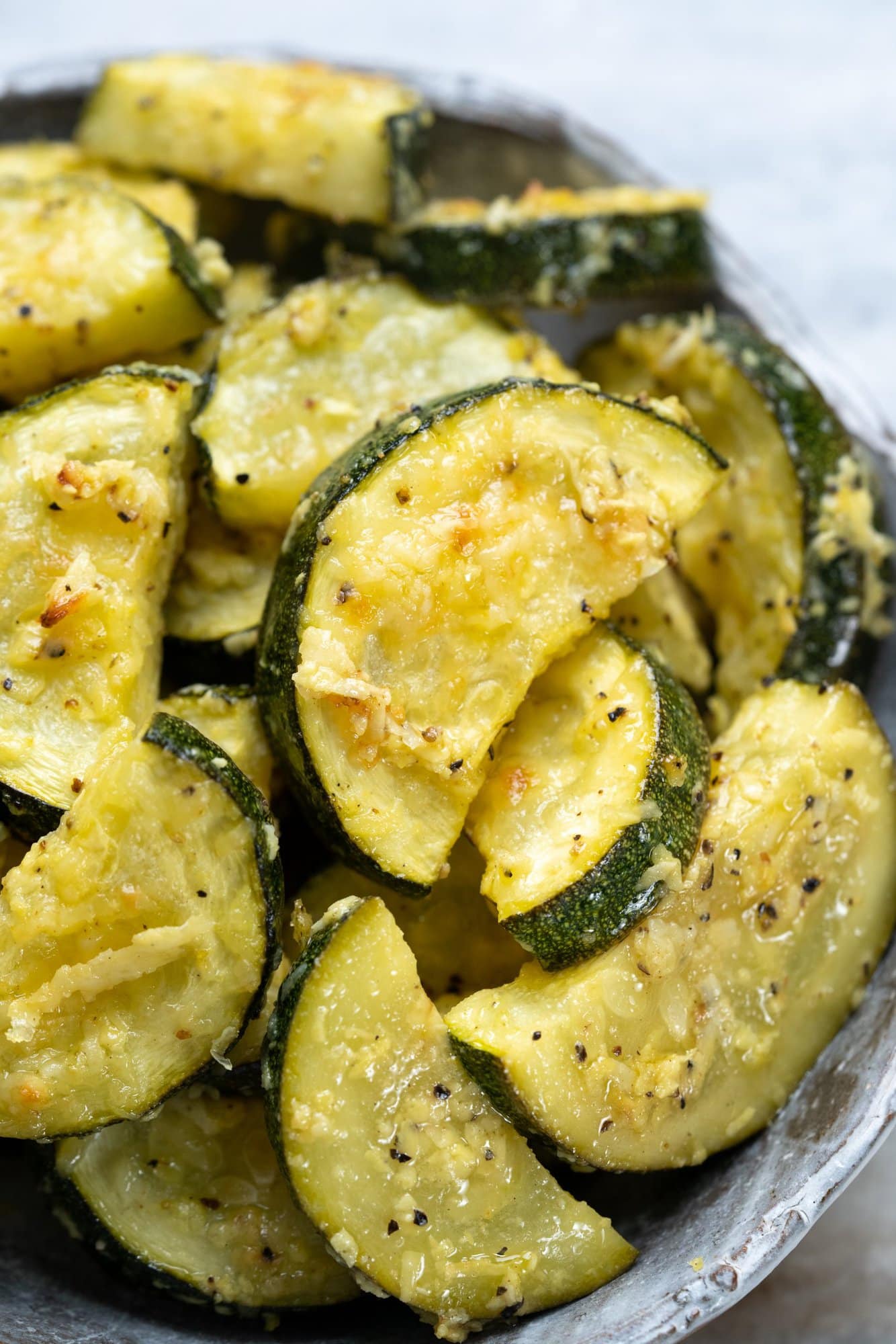 Zucchini is roasted in the oven with parmesan cheese and lemon pepper seasoning.