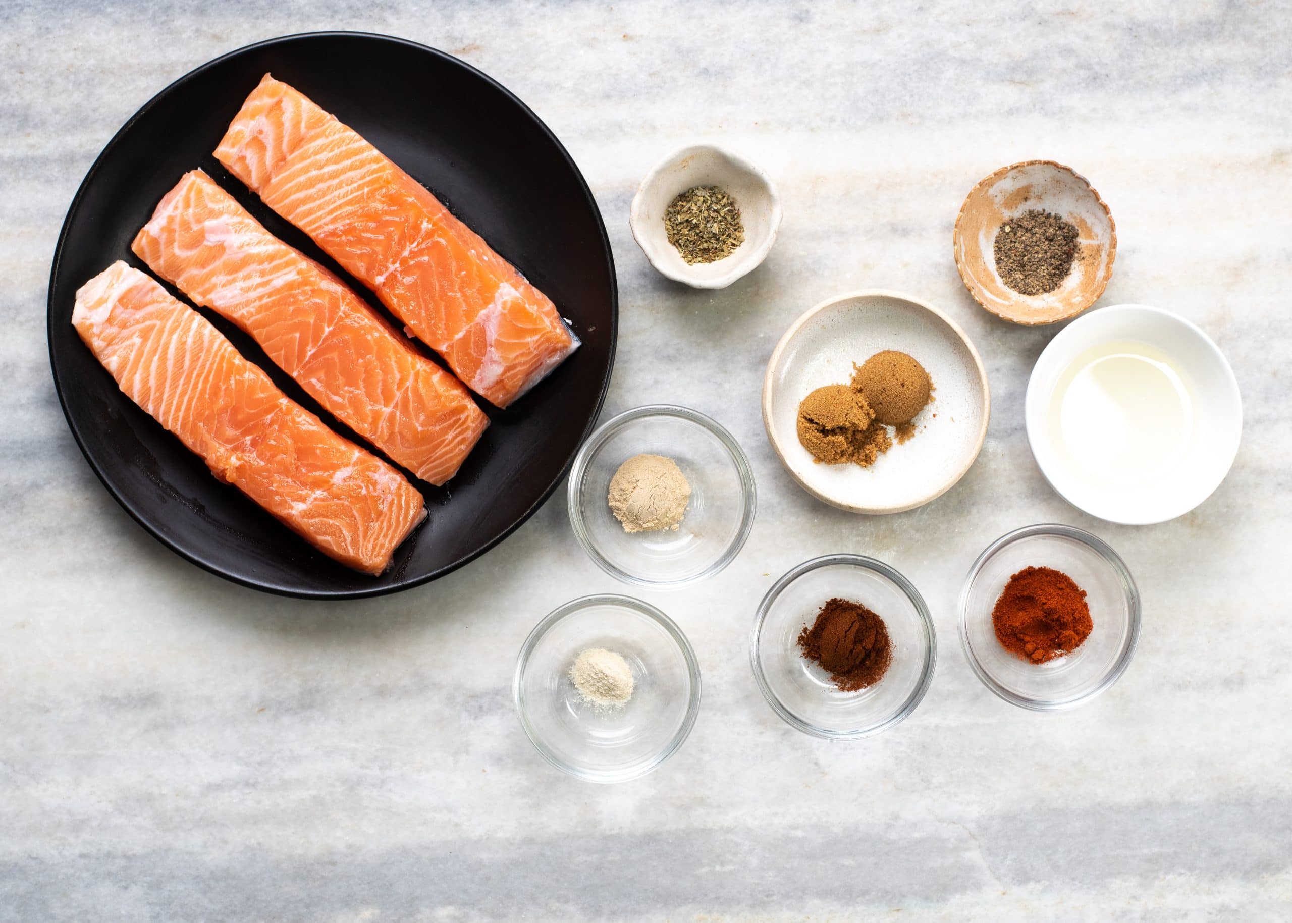 Ingredients needed to cook salmon in airfryer - salmon fillets, butter and ingredients to make a dry rub.