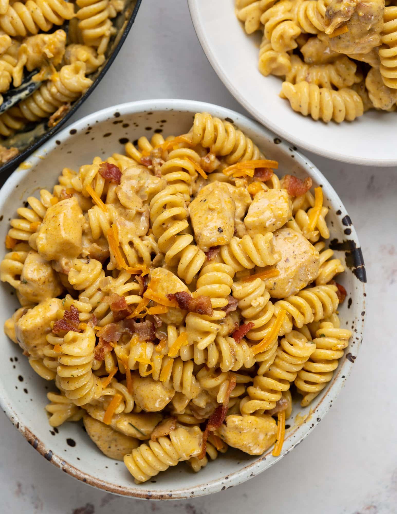 Chicken pasta with ranch seasoned sauce and bacon served in a bowl