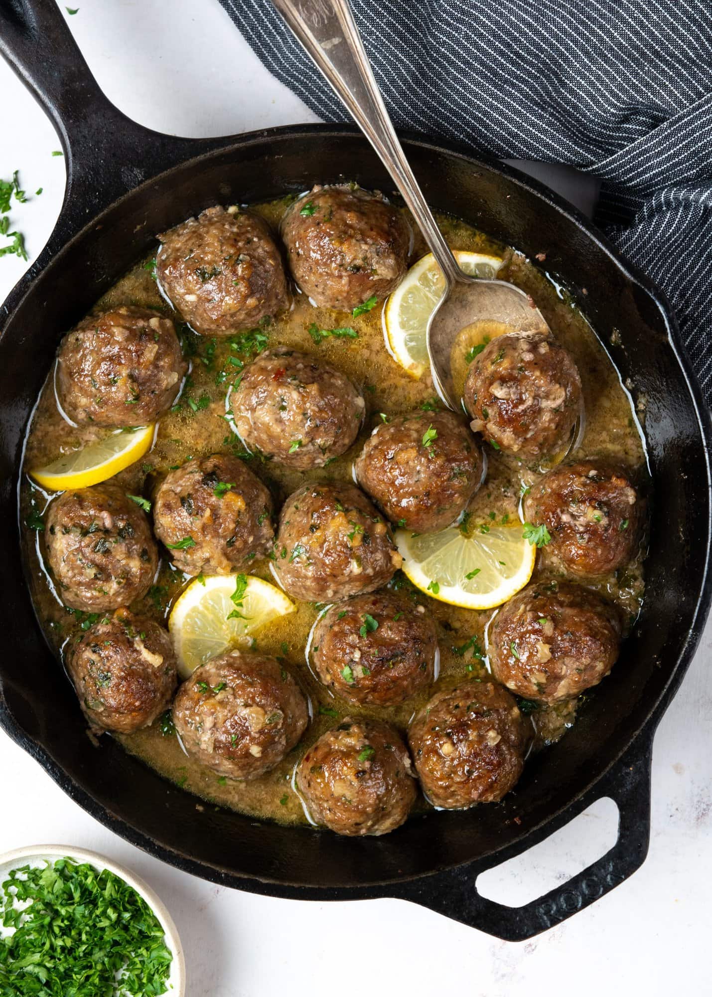 Juicy and tender Baked meatballs made in a butter garlic sauce in a skillet