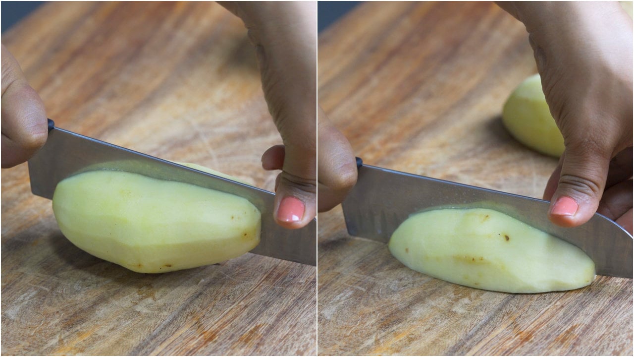 Potatoes sliced into halves using a knife to make breakfast potatoes.