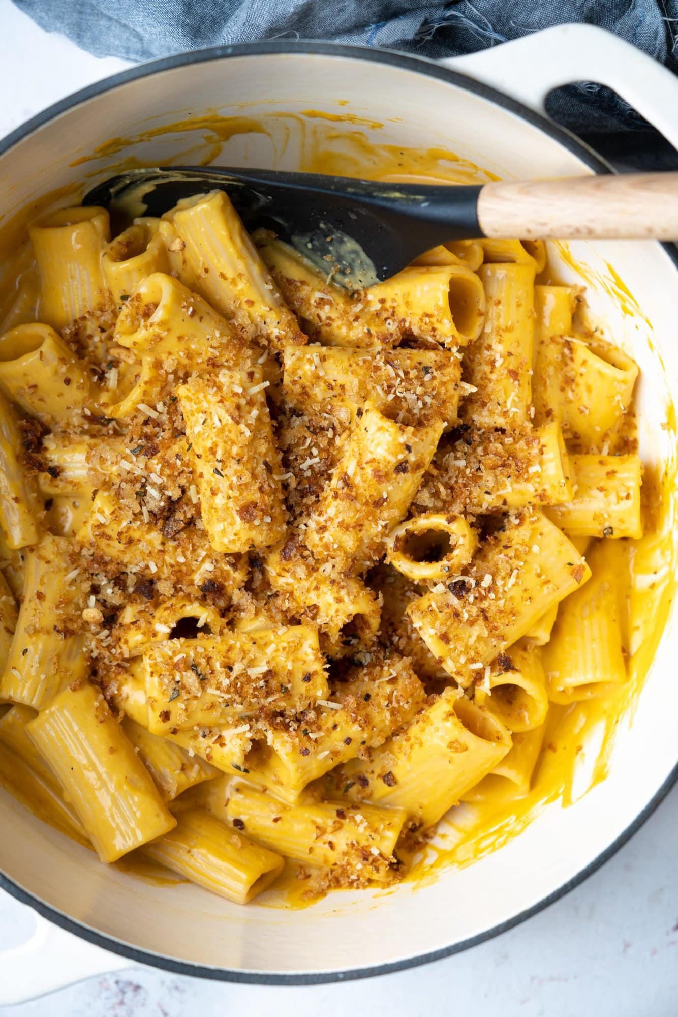 Top shot of a pot of creamy rigatoni pasta with roasted butternut squash sauce topped with crispy breadcrumb. 