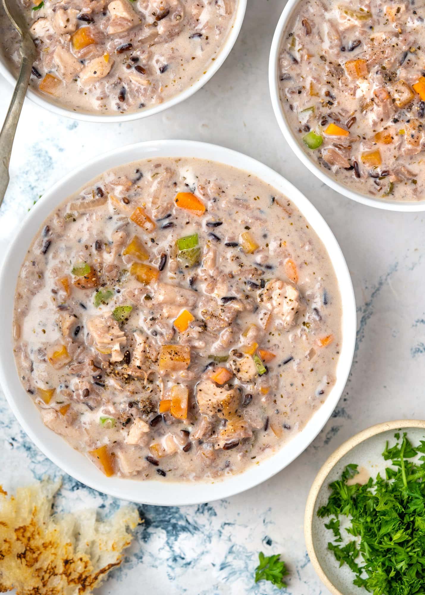 Bowl of chicken wild rice soup made with chicken, mushrooms, wild rice and veggies.