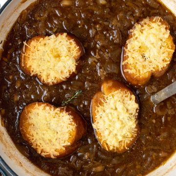 Cheese topped crusty bread on a sea of french onion soup