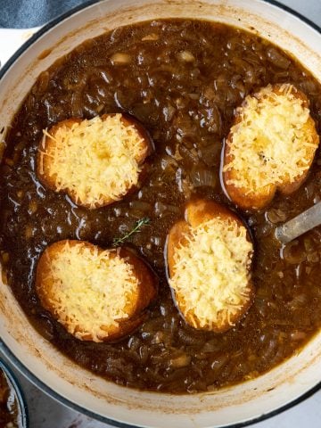Cheese topped crusty bread on a sea of french onion soup