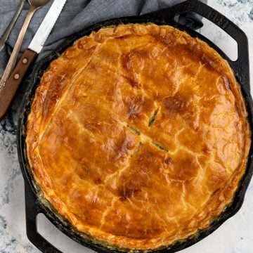 Flaky pastry in the top crust of chicken pot pie baked in a skillet