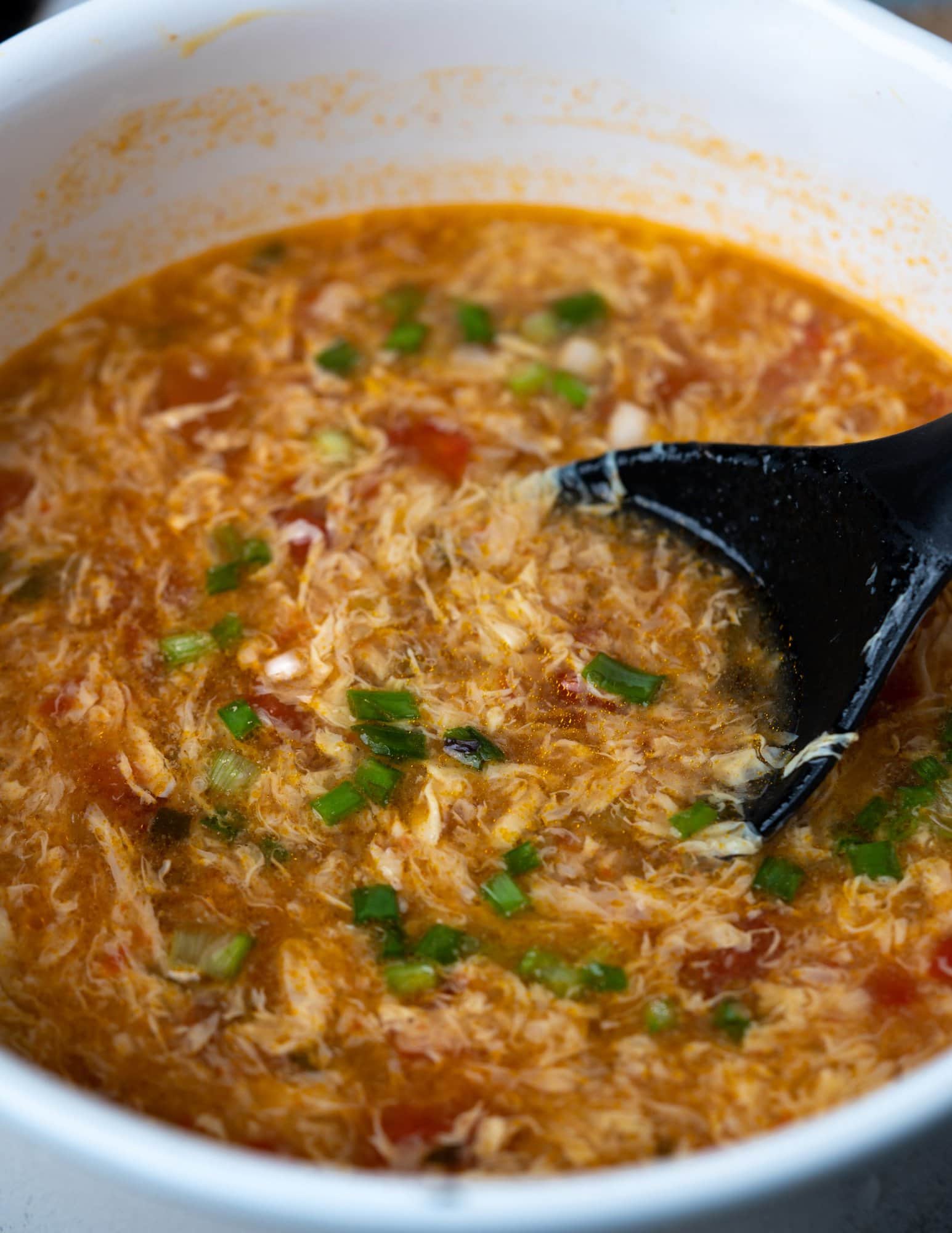 Pot of Egg Drop Soup with tomatoes. 
