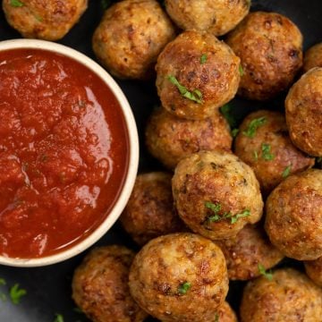 Chicken meatballs baked with a crisp exterior and tender and juicy chicken inside. Served with marinara sauce.