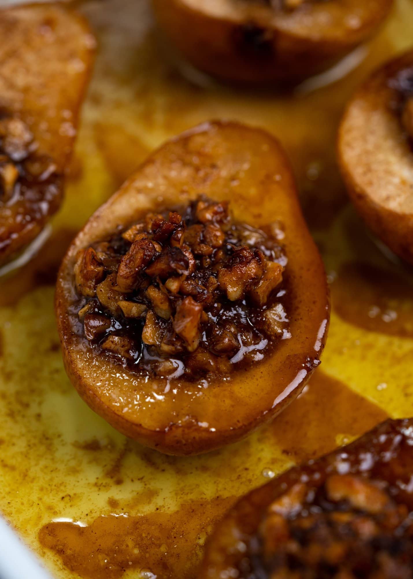Mixture of crunchy Walnuts, maple syrup and cinnamon put in the core of pears and baked 