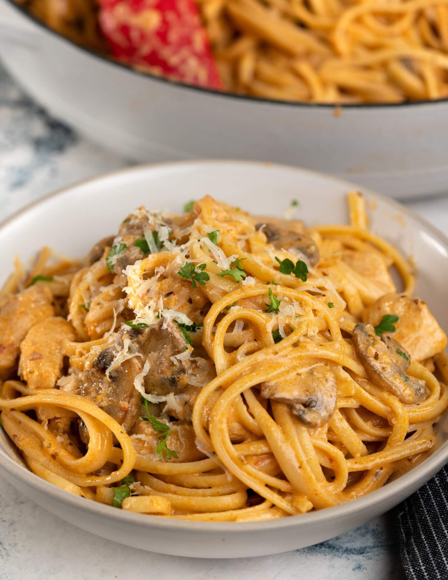 This spicy chicken pasta in a rich garlicky tomato sauce is creamy and has a perfect hint of spice. Roasted mushrooms and juicy chicken breast makes this Chicken pasta a filling meal on its own.