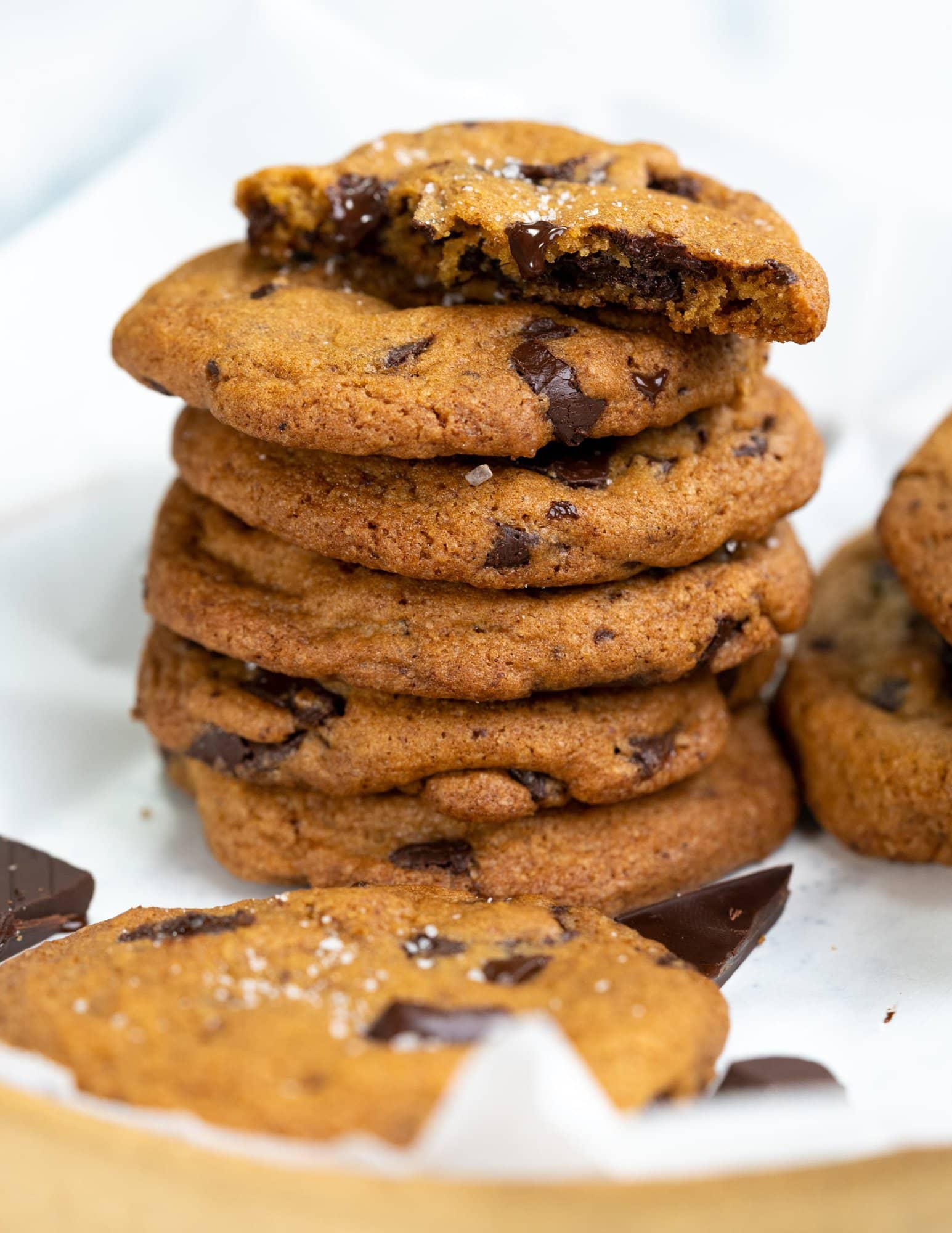 brown butter chocolate chip cookies stacked with the topmost cookie showing the soft chewy texture 