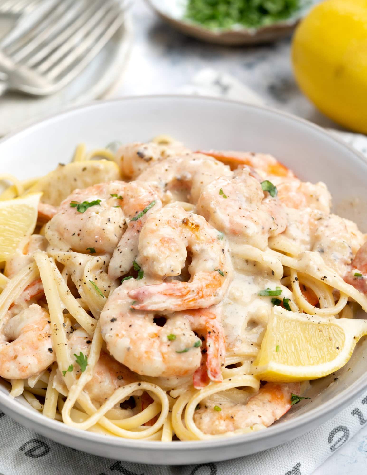A bowl of Pasta topped with the creamy garlic Shrimp.