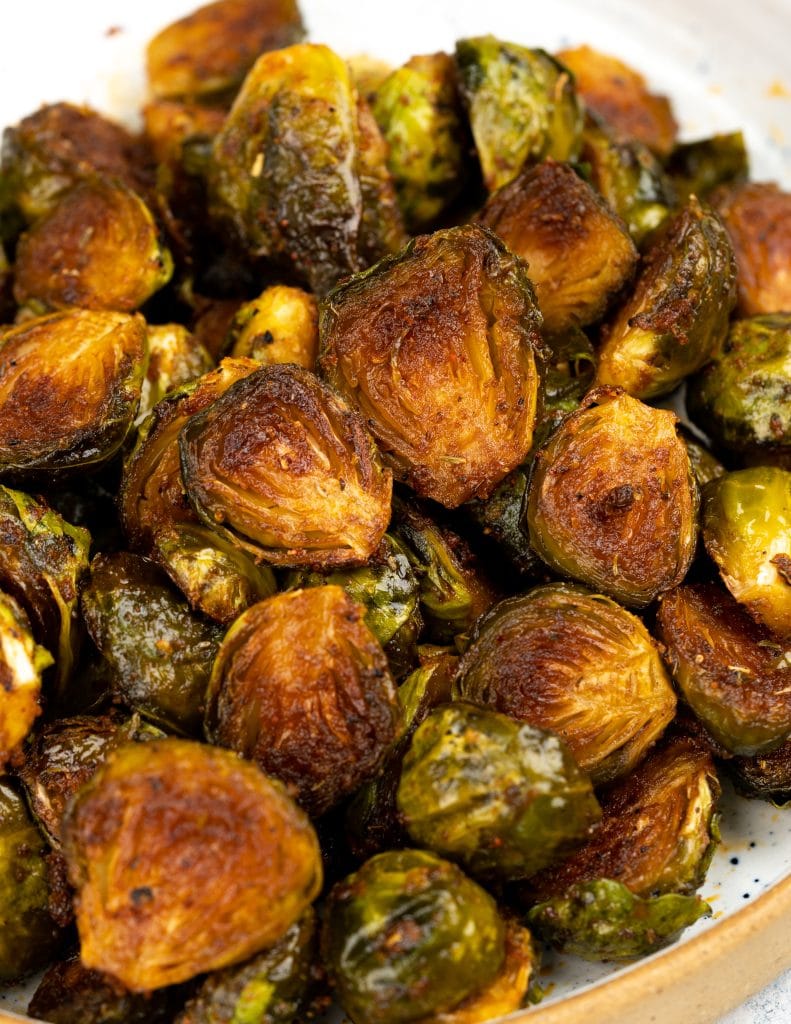 Close up view of oven roasted brussels sprouts showing a brown caramelization on the outside