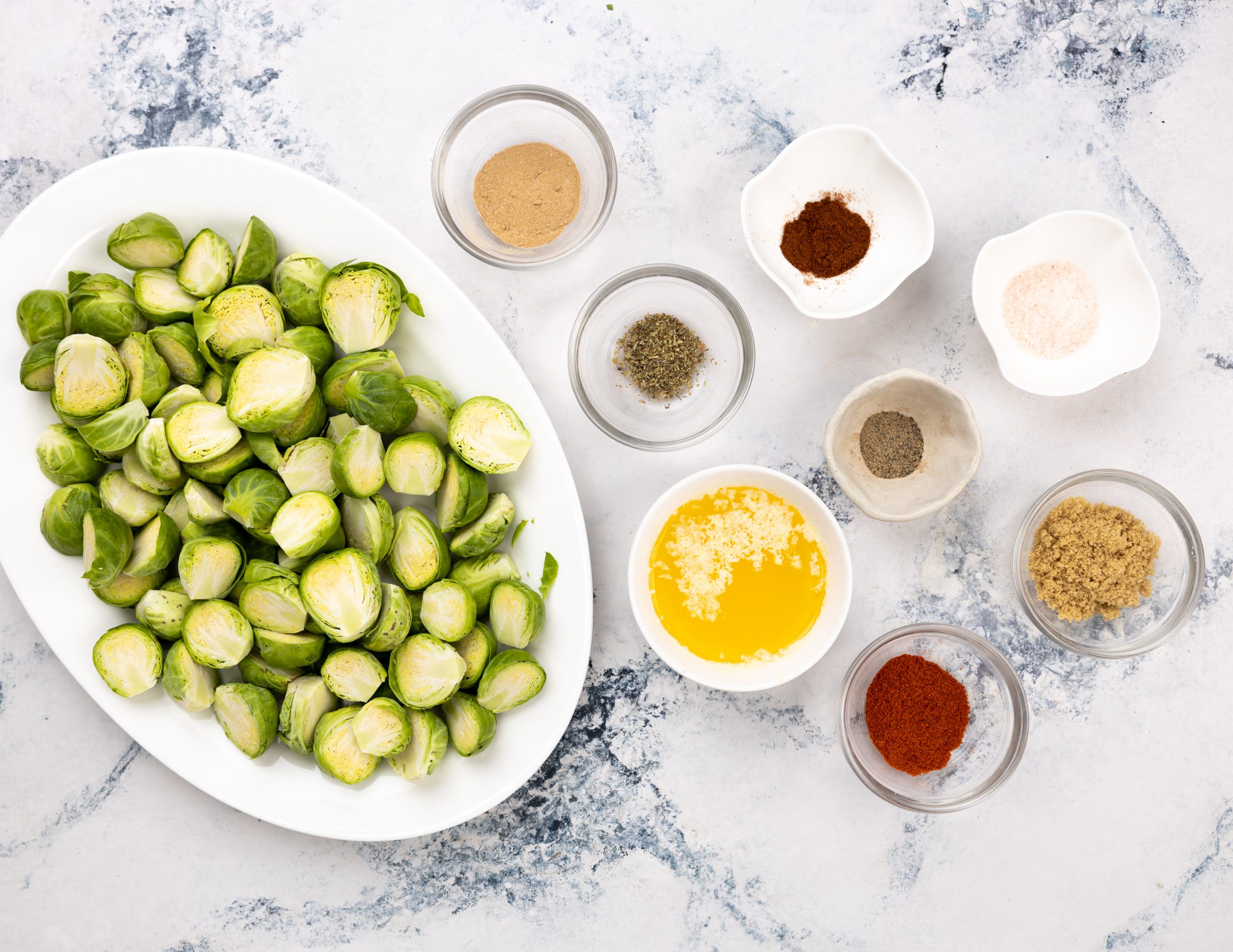 Chopped sprouts, butter, garlic powder, paprika, pepper and Italian seasoning are needed to oven-roast brussel sprouts