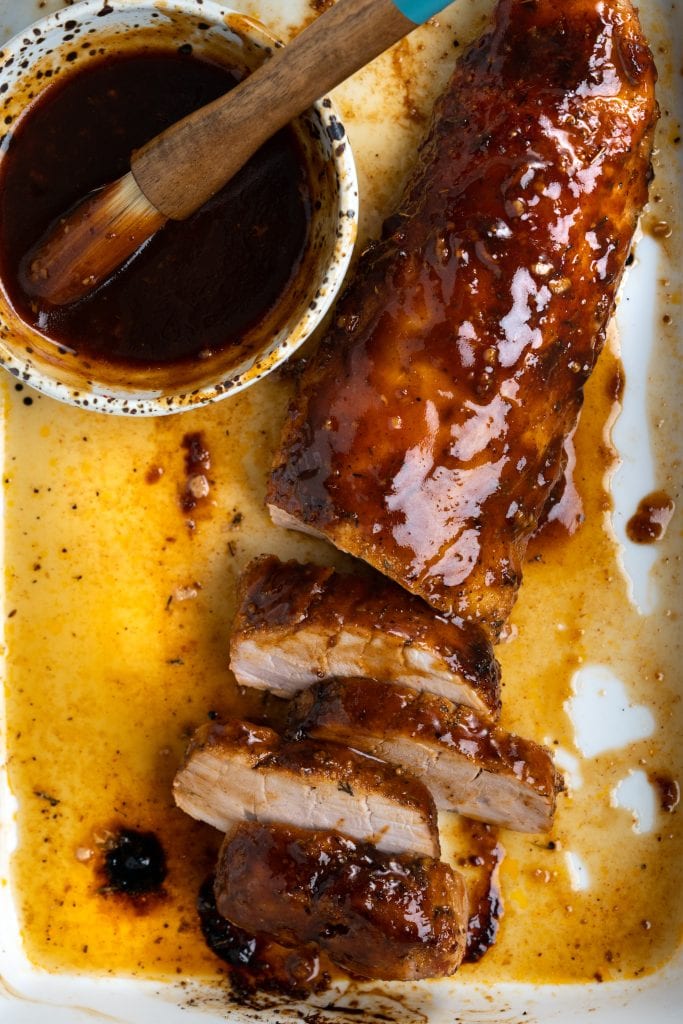 Top view of baked pork tenderloin, brushed with a shiny, flavorful BBQ glaze and chopped.