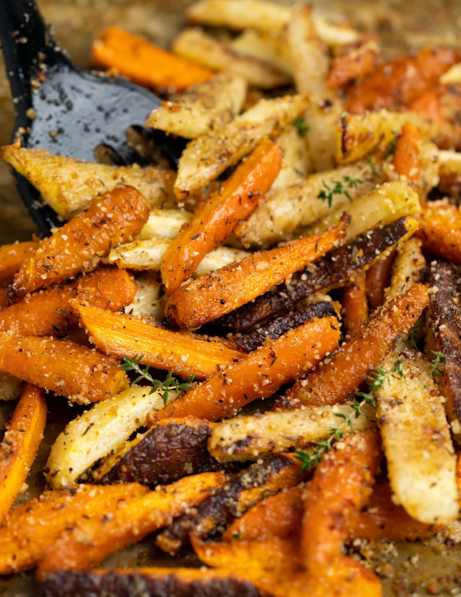 Carrots tossed in butter, olive oil, garlic, herbs, and parmesan cheese makes the best ever roasted Carrots. The natural sweetness of the caramelized carrots complements the savory seasoning, making it one of our favourite side dishes. 