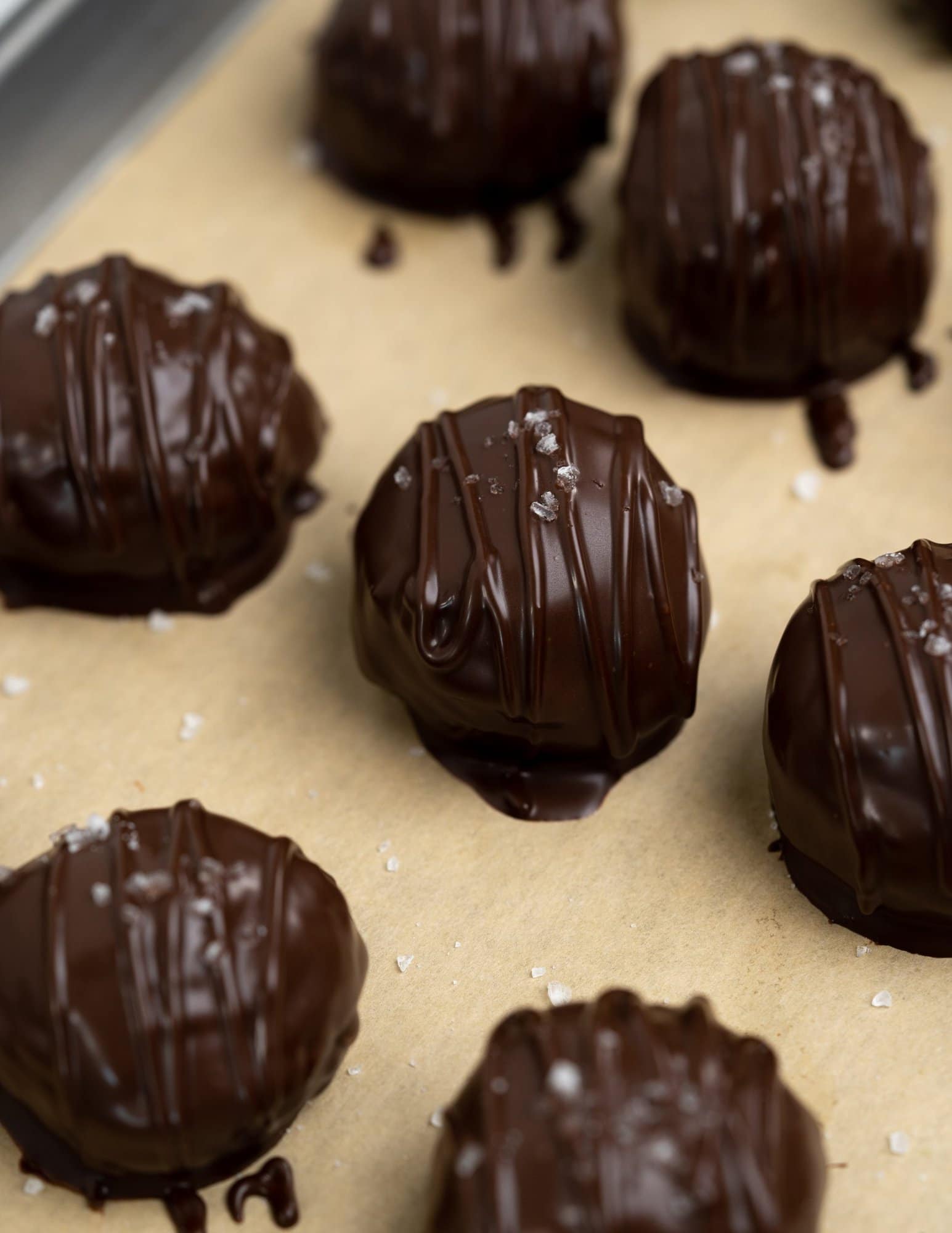 Peanut butter balls are covered with dark chocolate and topped with flaky sea salt. Added rice cereals gives an crackle. 