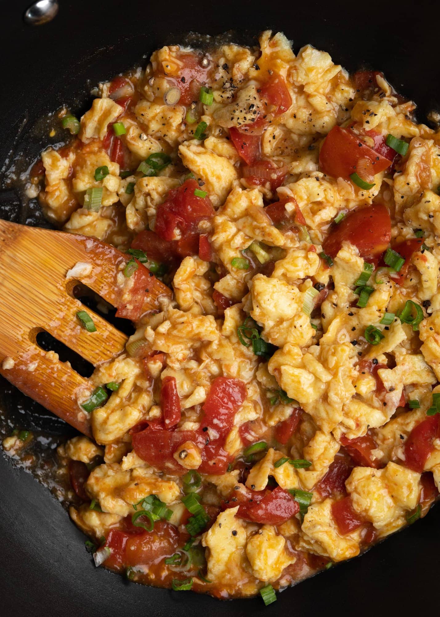 Tomato Egg stir fry is a classic Chinese dish. Soft scrambled egg is tossed with ripe tomato wedges, then seasoned with soy sauce & sesame oil for a flavor-packed dish. 