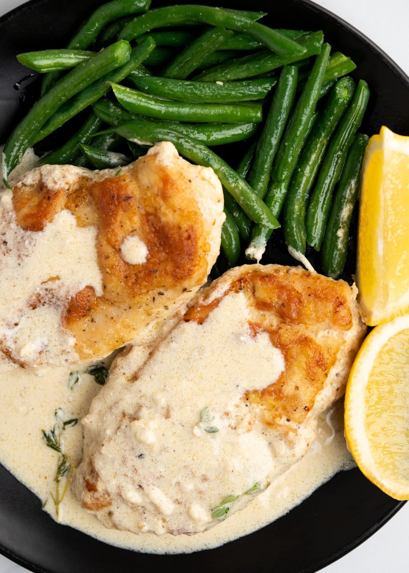Crispy chicken breast served with creamy lemon sauce and side of veggies. 