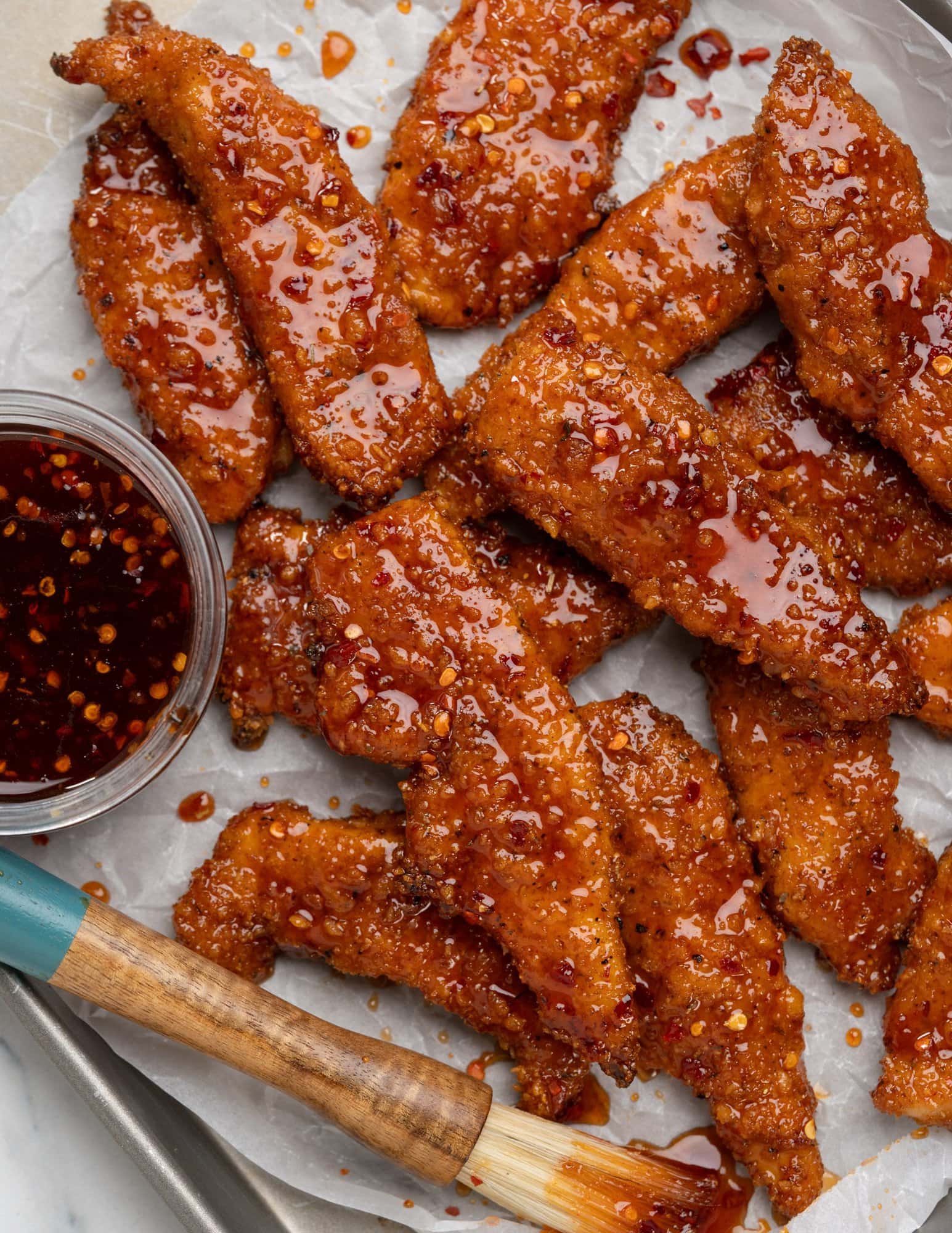 Top view of Chicken tender baked in oven unitl crispy and then tossed in  hot honey sauce.