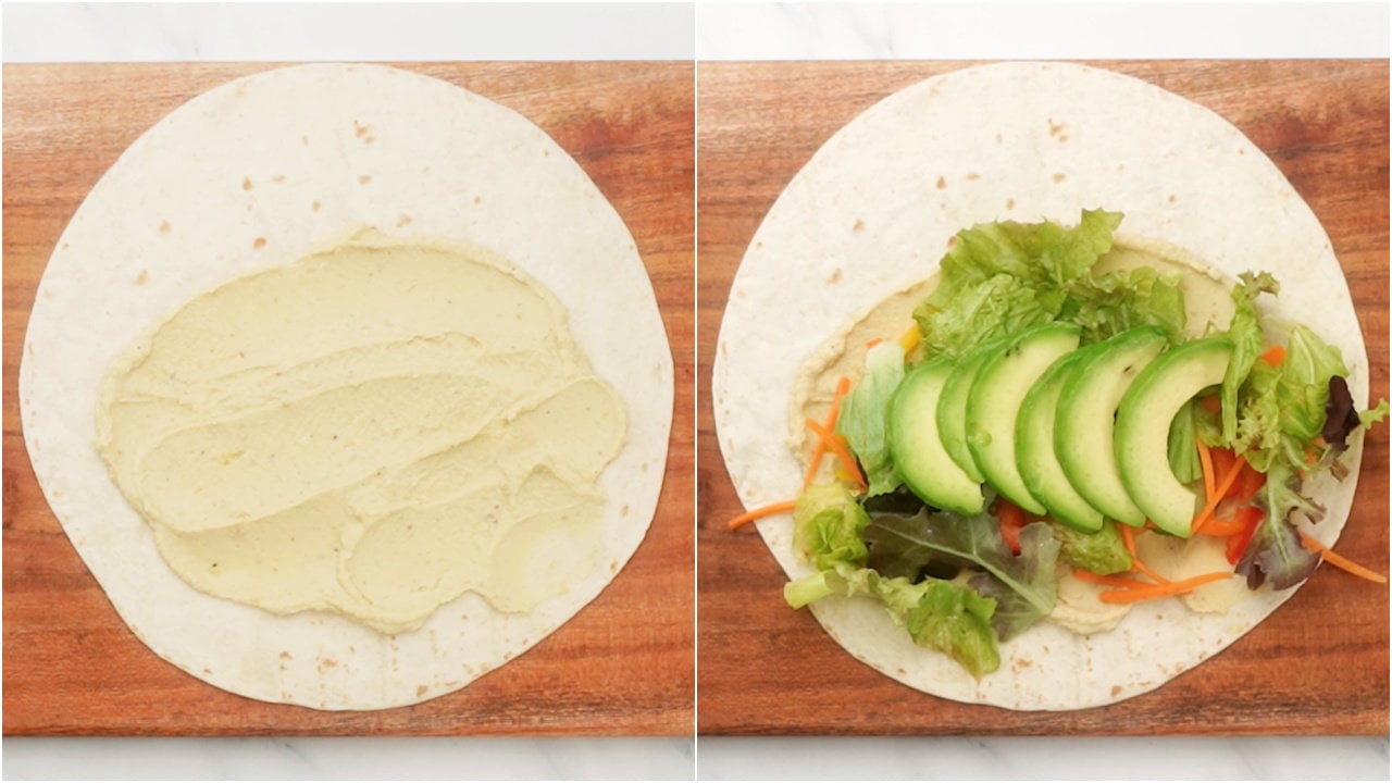 Layer tortillas with hummus. Then top it with cucumber, carrots, lettuce, pepper, avocado slices
