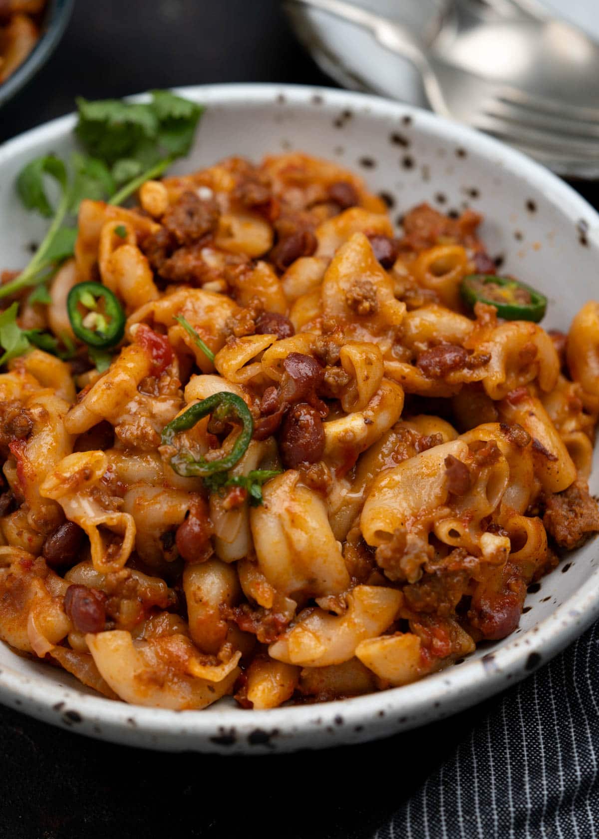 Bowl of chili mac and cheese with macaroni, red beans, ground beef and lots of cheese.