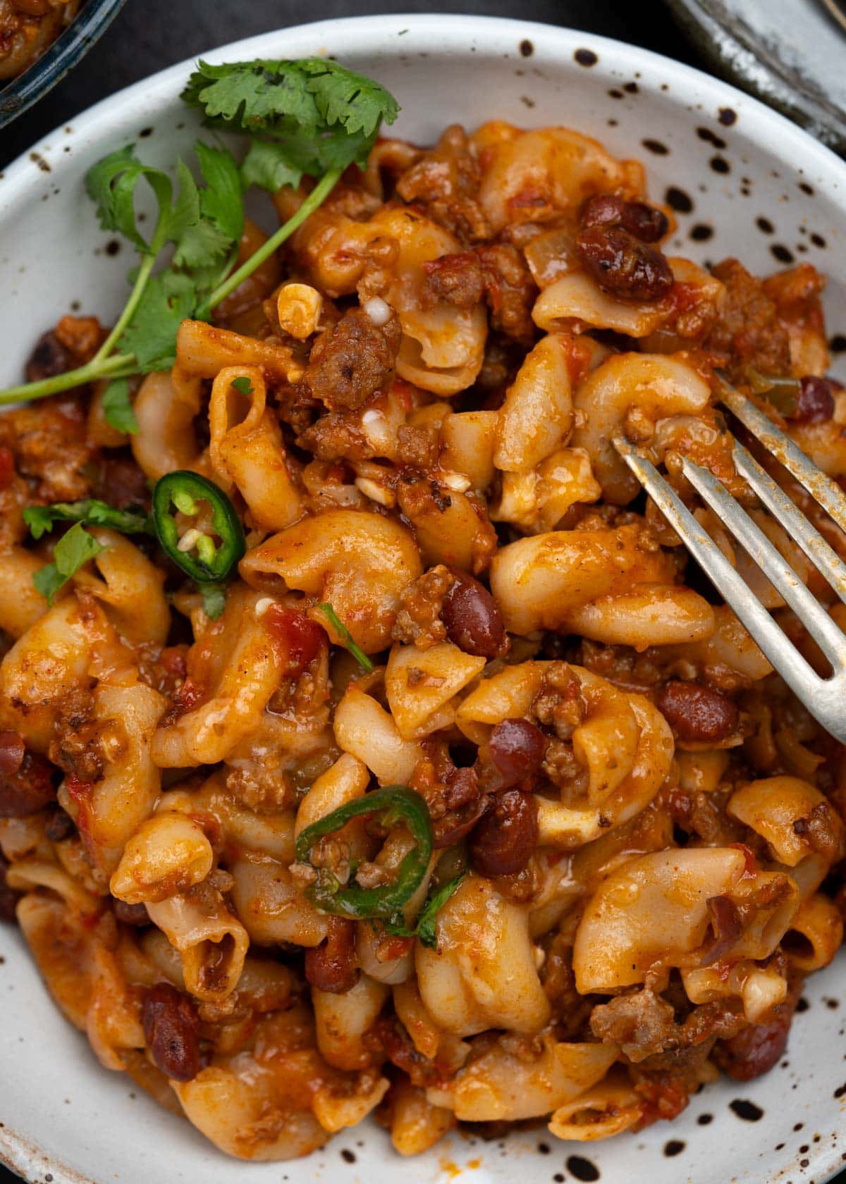 close up of on pot chili mac and cheese with ground beef, pasta, red beans and cheese. 