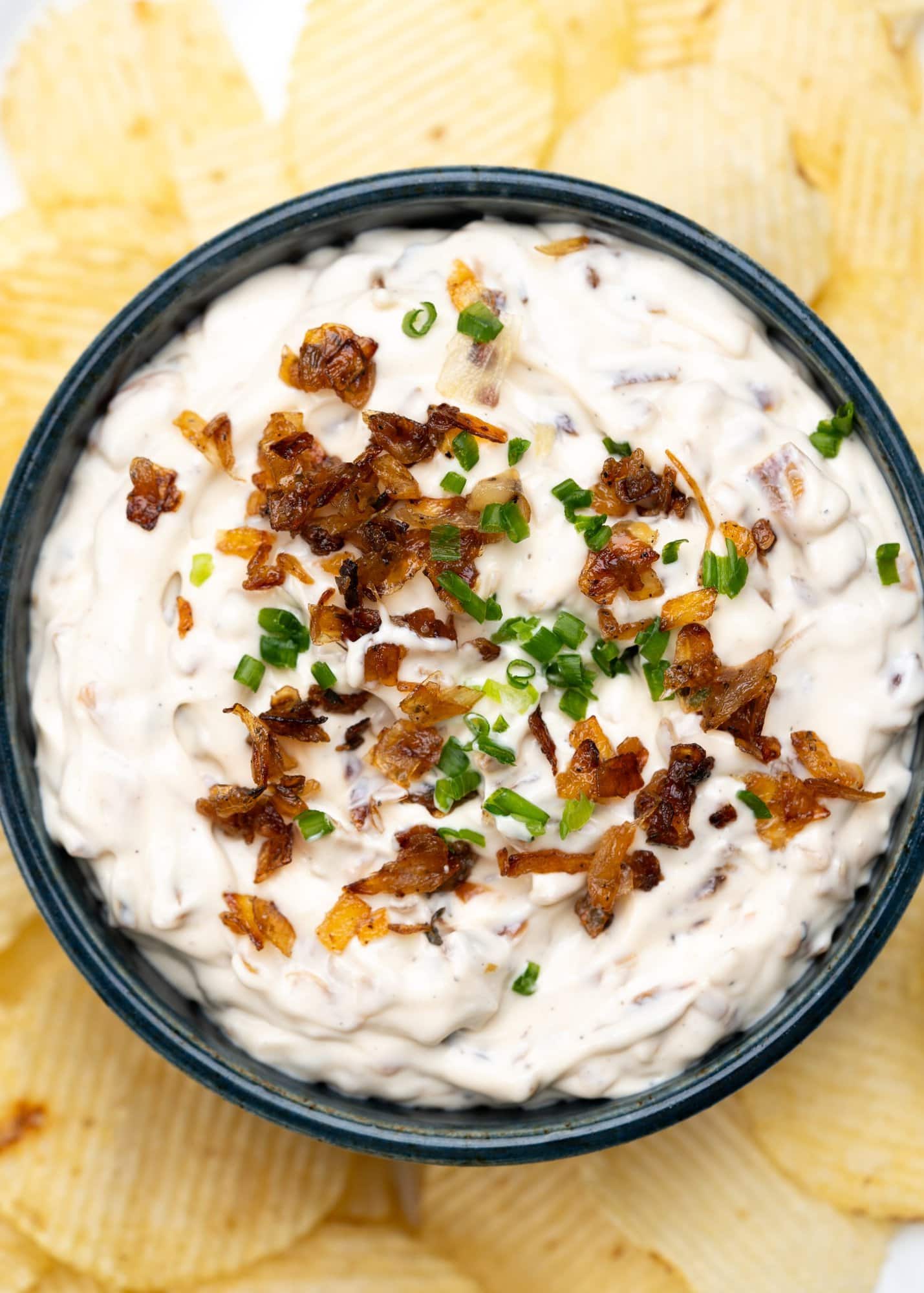 French onion dip garnished with chives and caramelized onion. Served with potato chips. 