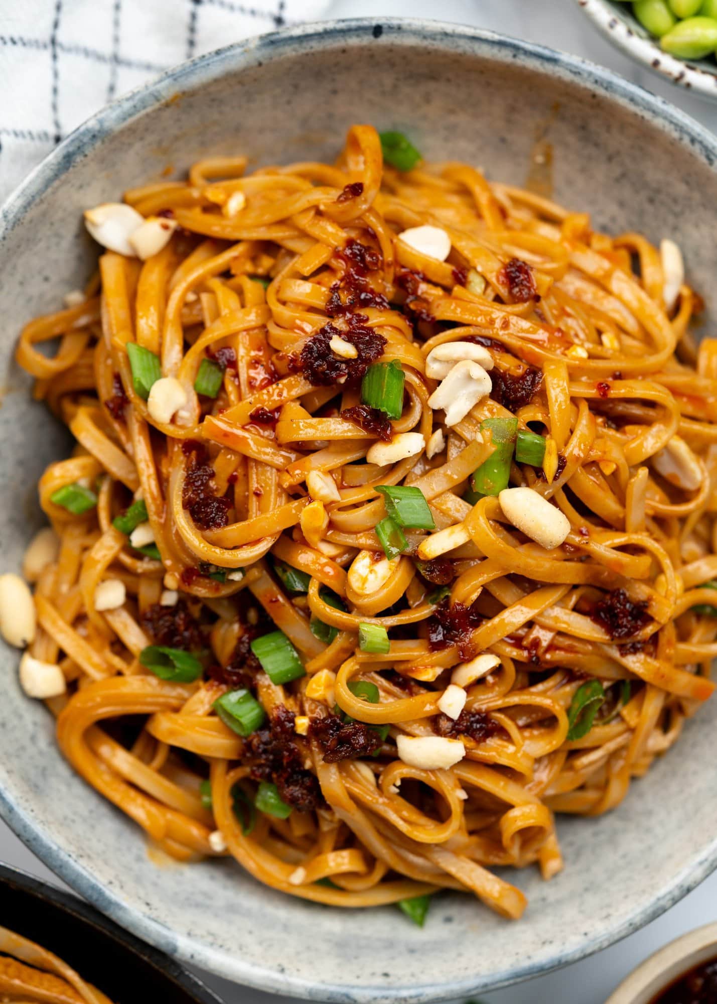 Rice noddles tossed in a creamy spicy peanut butter sauce and topped with crunchy peanut, green onions and chili crisp.