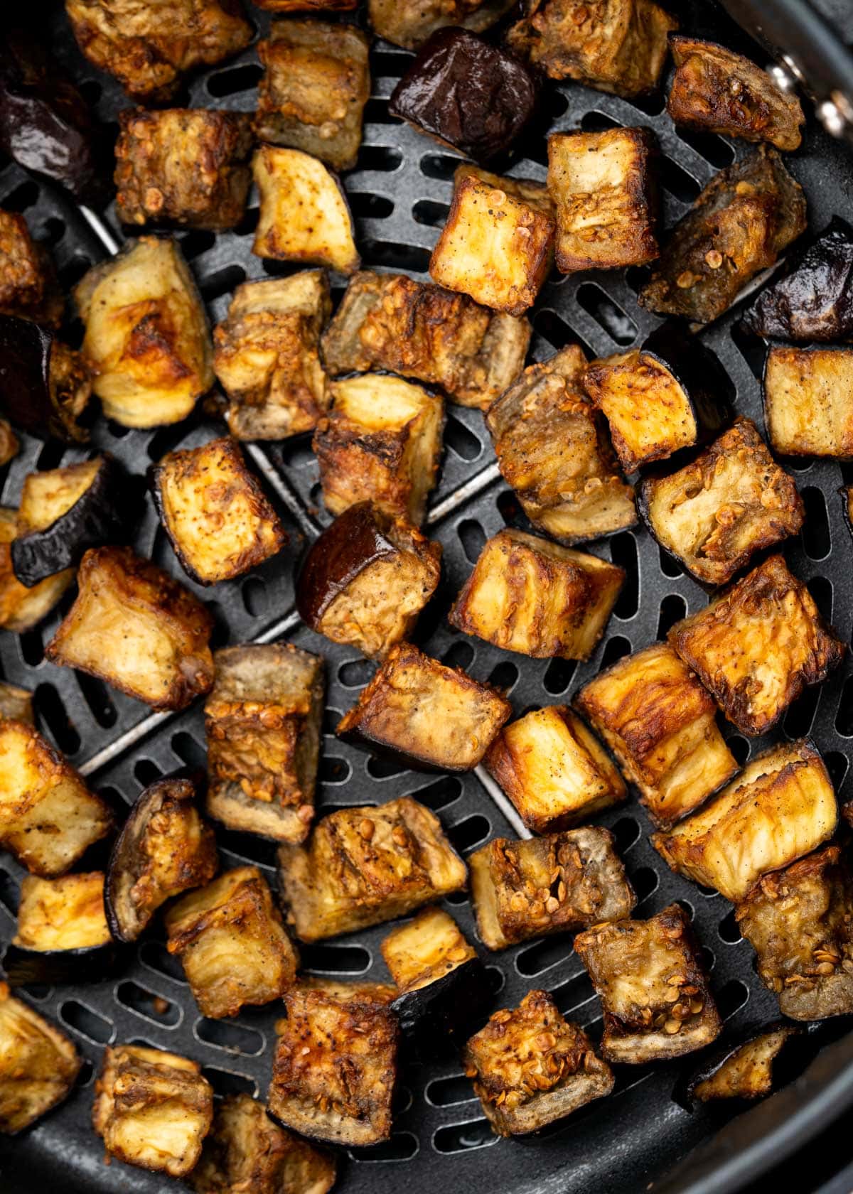 Top view of crispy Eggplant bites in an airfryer basket.  