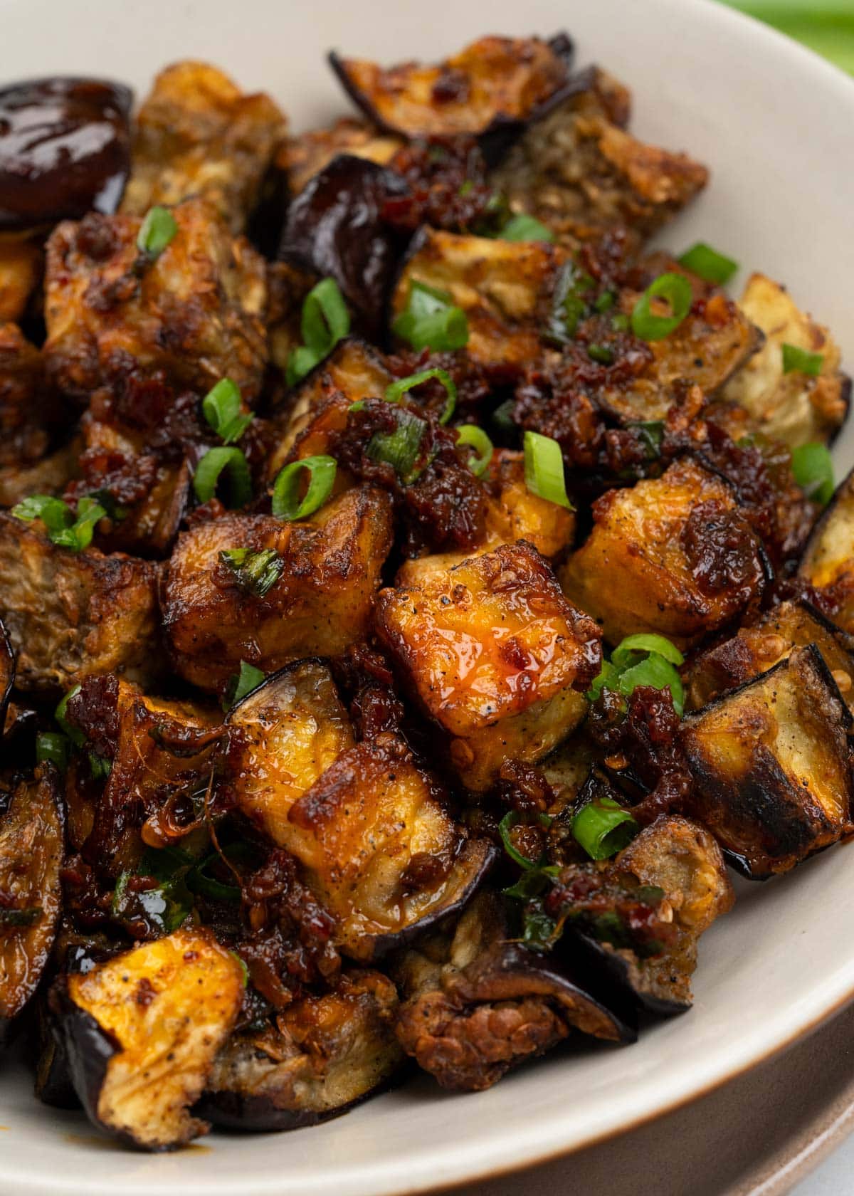 Crispy Air fryer eggplants tossed in Chilli oil dressing and a garnish of green onion.