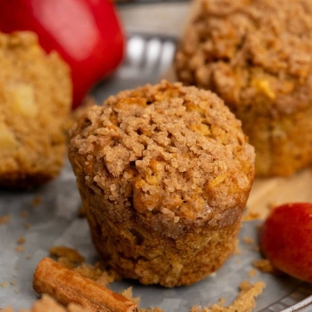 Apple muffin on plate.