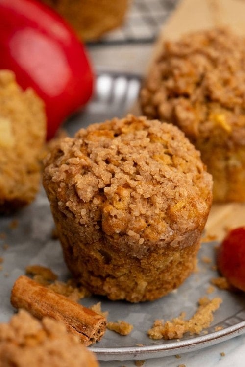 Apple muffin on plate.