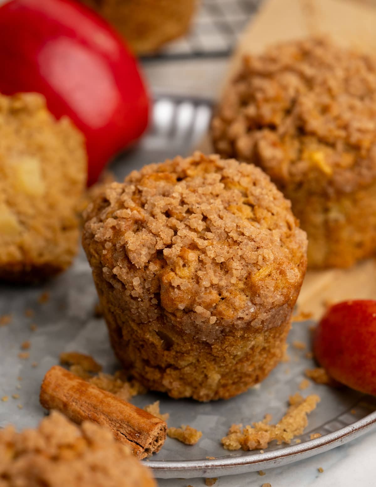 Cinnamon apple muffin with crunchy cinnamon sugar topping, having chunks of apple and is tender and light inside.