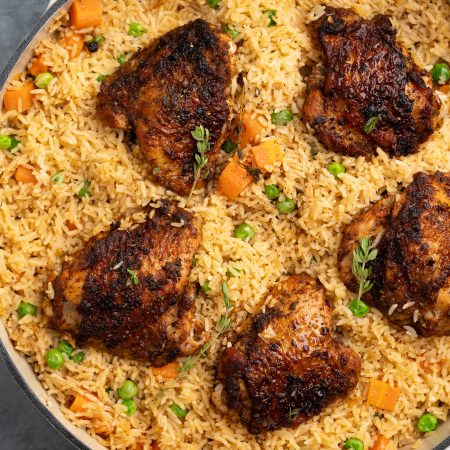 This oven baked chicken and rice has crispy chicken thighs, flavour packed rice and to make it wholesome I have also added veggies to it.