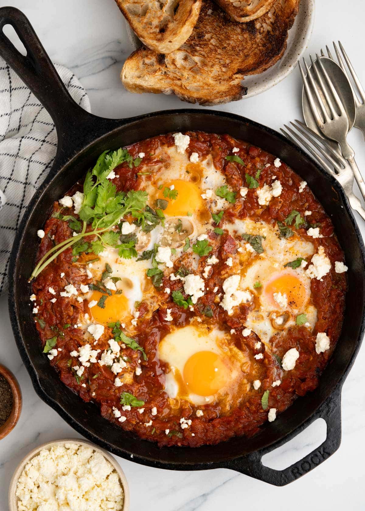 Shakshuka with feta , egg in a aromatic spiced tomato and red pepper sauce. 