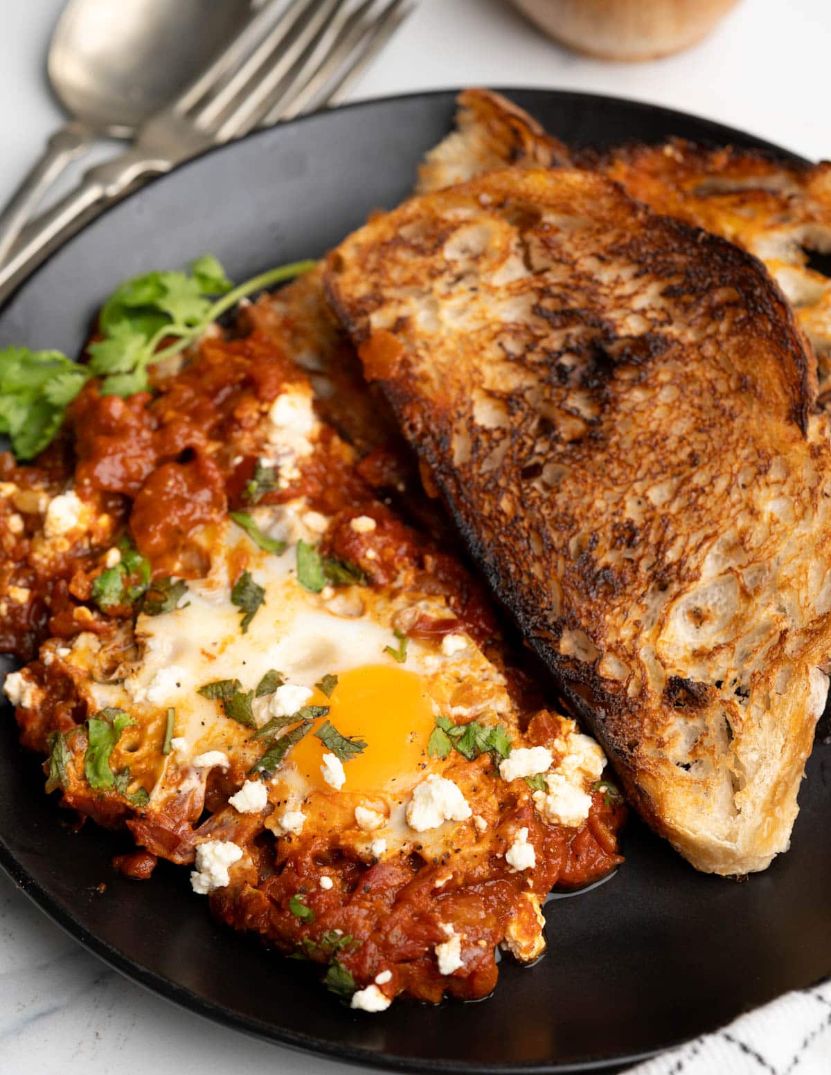 Shakshuka served with toasted sourdough bread.