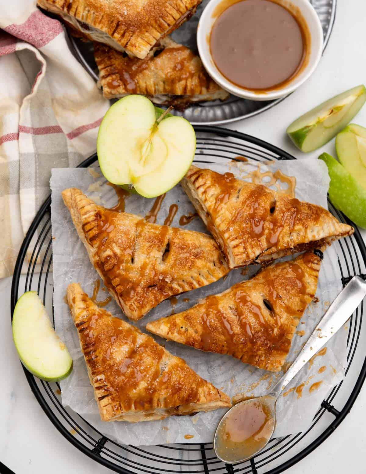 Top view of Golden brown crispy Apple turnovers drizzled with caramel. sauce.