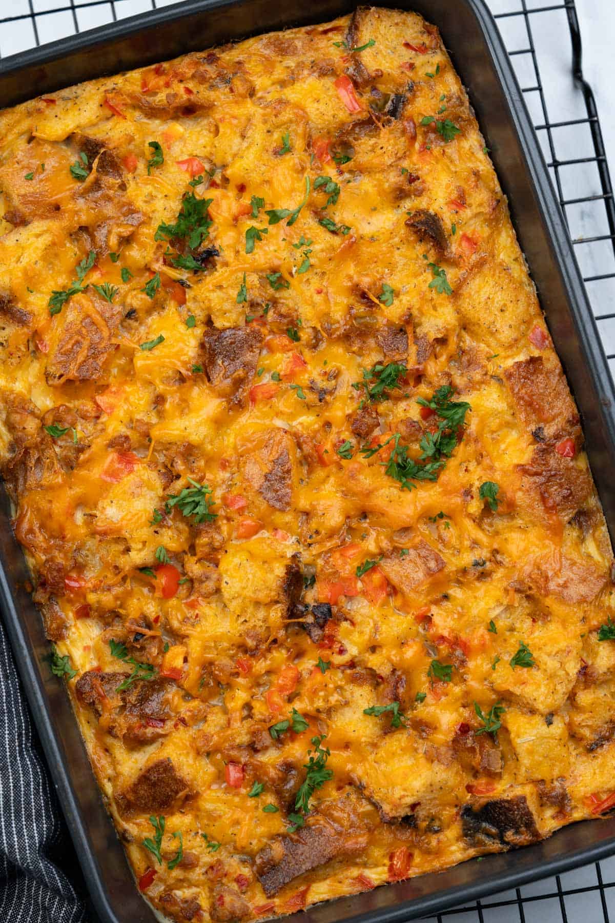 Bread, eggs, sausage and cheddar cheese baked into a casserole. This breakfast is filling and delicious.