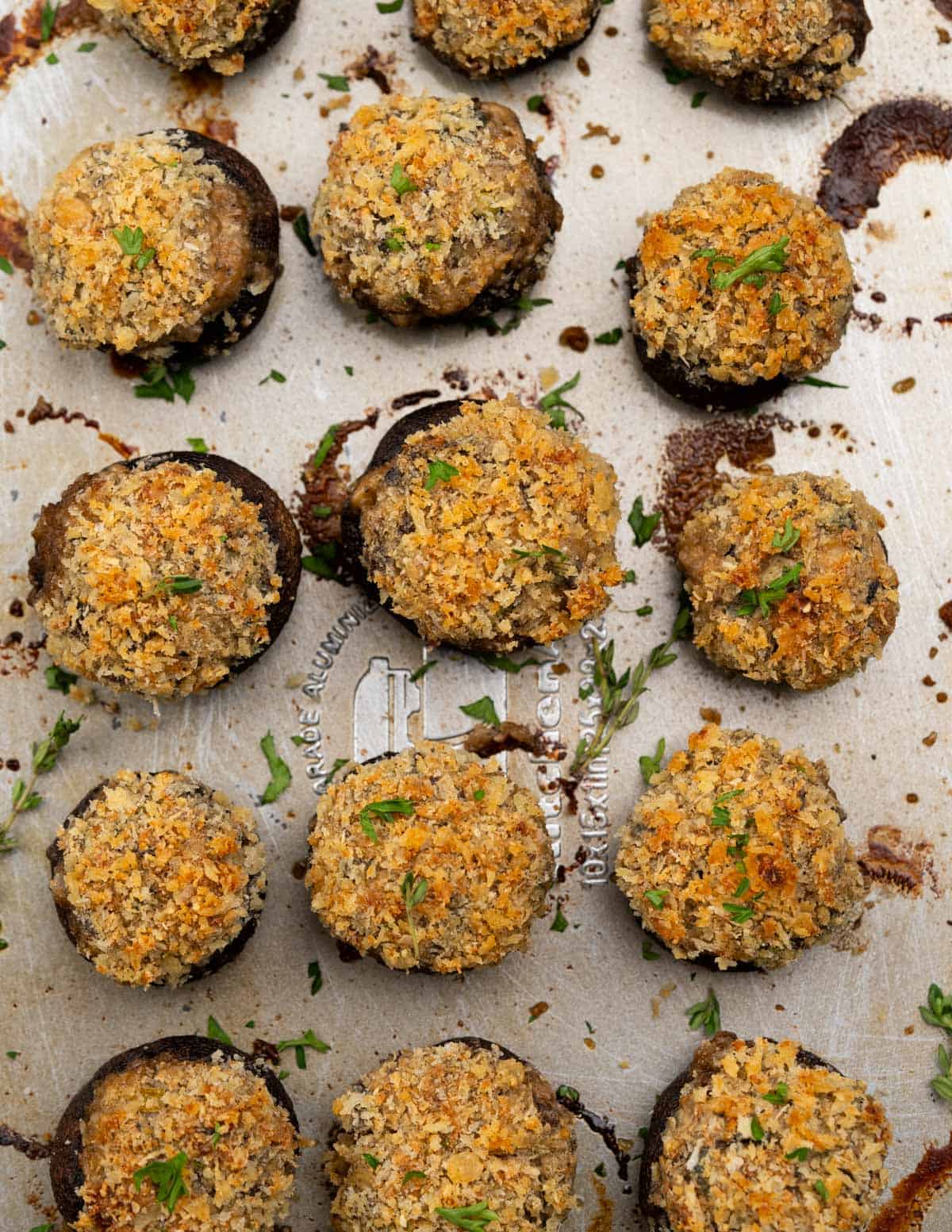 top view of Baked Cremini mushrooms are stuffed with savoury filling of cream cheese, walnuts, fresh herbs and then topped crunchy breadcrumb parmesan topping. 