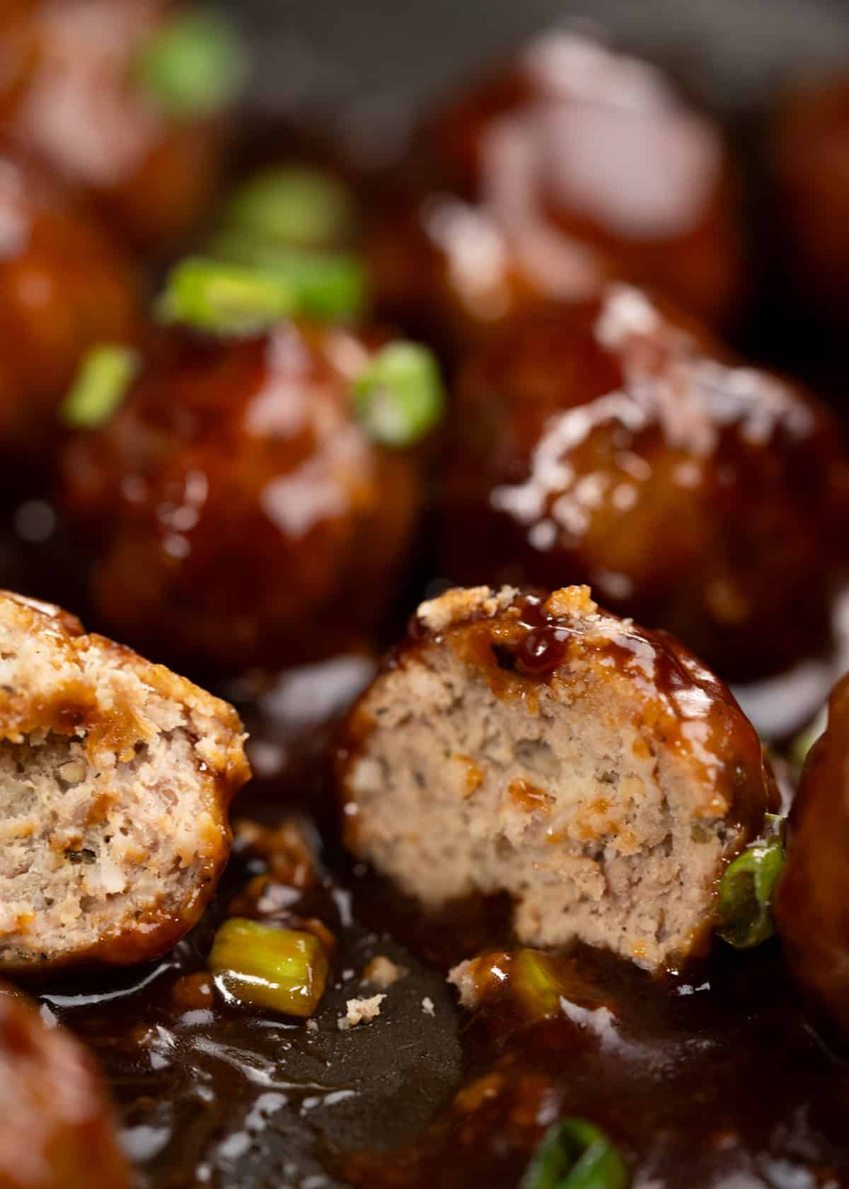 Cross section of sweet and sour meatballs showing how juicy and moist they are. 