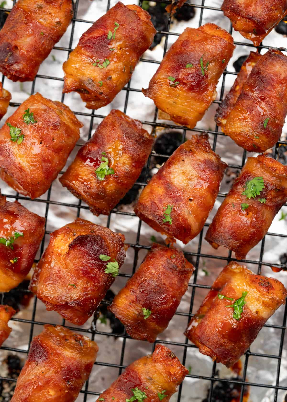 Chicken breast pieces seasoned with a sweet and spice blend, wrapped in bacon, and baked until crispy.  