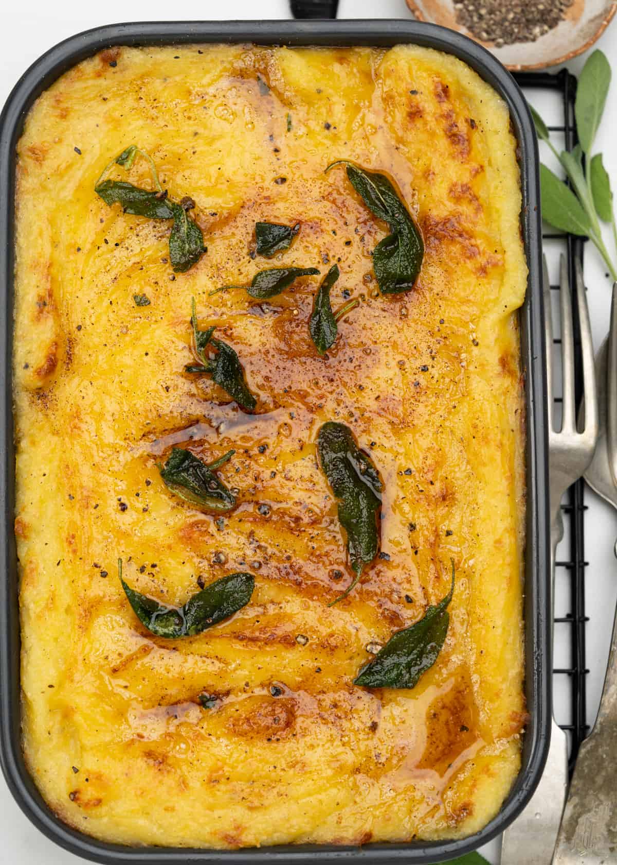  creamy fluffy mashed potato with lots of cheese is baked into a casserole. Top it with brown butter and crispy sage