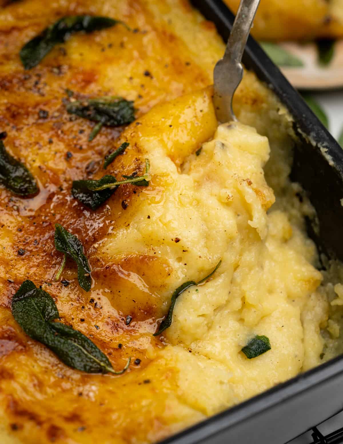  creamy fluffy mashed potato with lots of cheese is baked into a casserole. Top it with brown butter and crispy sage