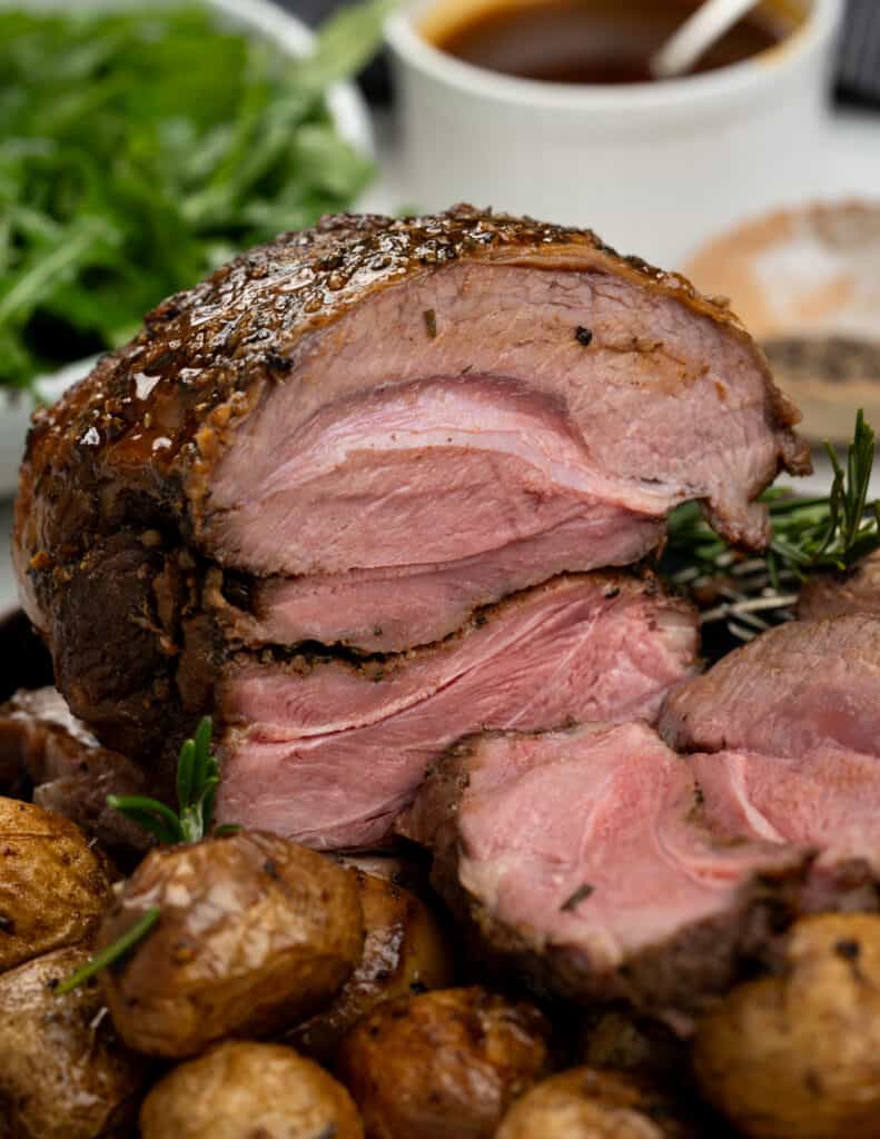 Boneless Lamb roast in the oven to pink medium-rare doneness and served with roasted potatoes