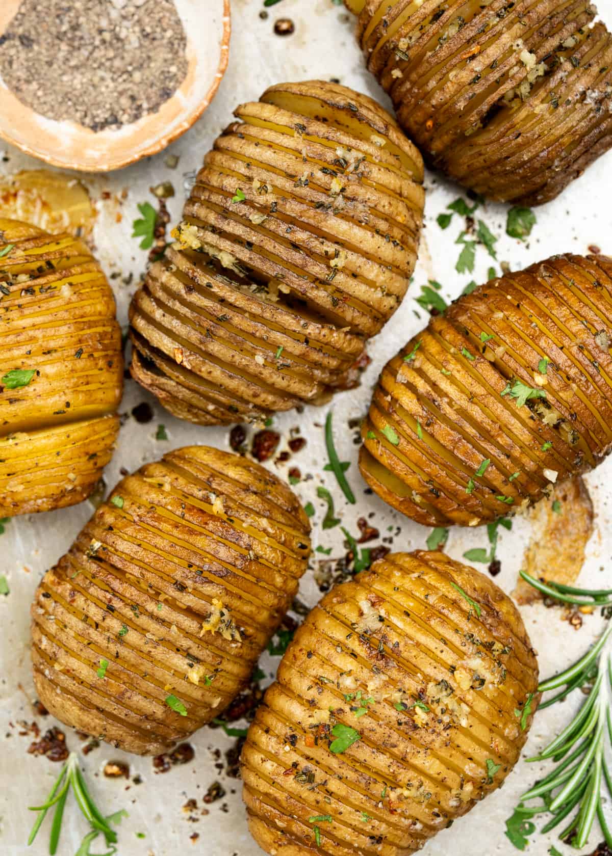 Hasselback Potatoes are a fun way to serve baked potatoes. Potatoes are sliced thin, flavoured with garlic rosemary butter, then baked until they are crispy on the outside and cooked perfectly on the inside. 